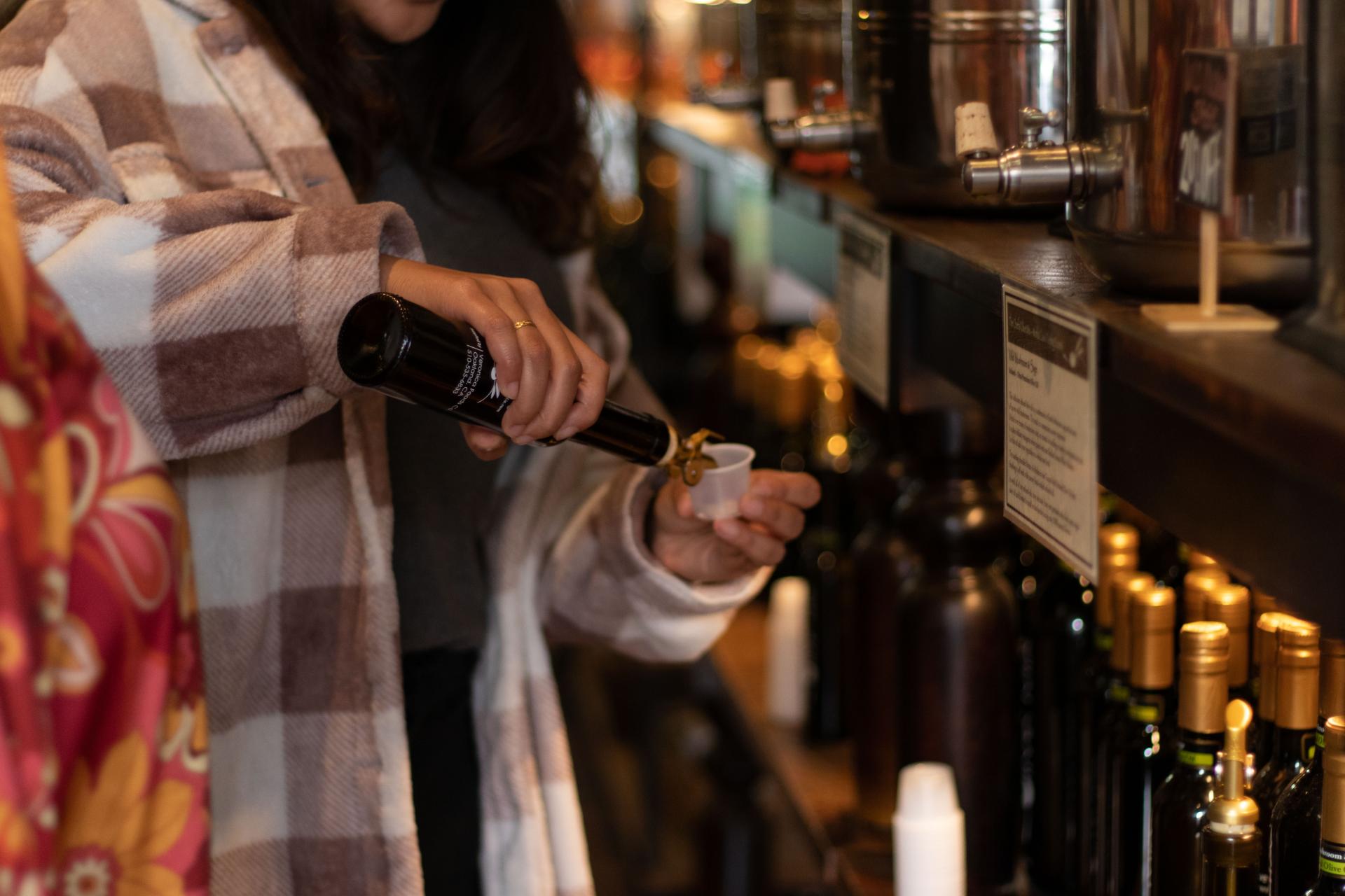 Person pouring wine at cocktail bar